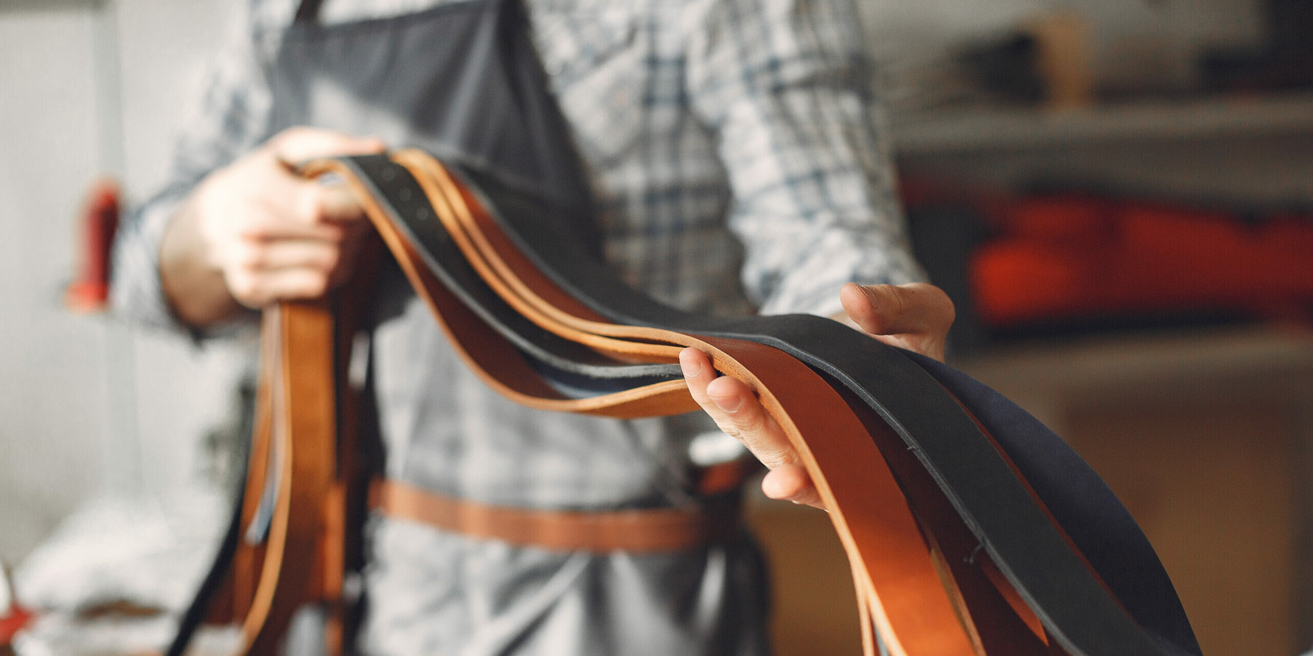 Man in a studio creates leather ware